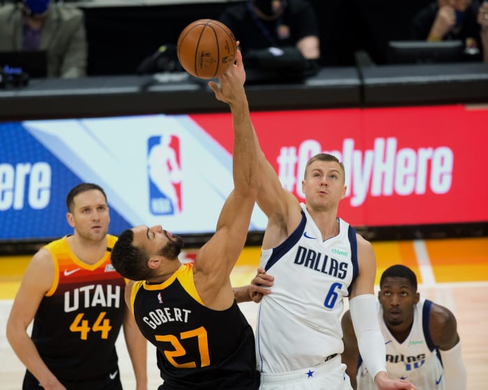Rudy Gobert (27) and Kristaps Porzingis (6) tip-off a game between the Utah Jazz and Dallas Mavericks earlier this season